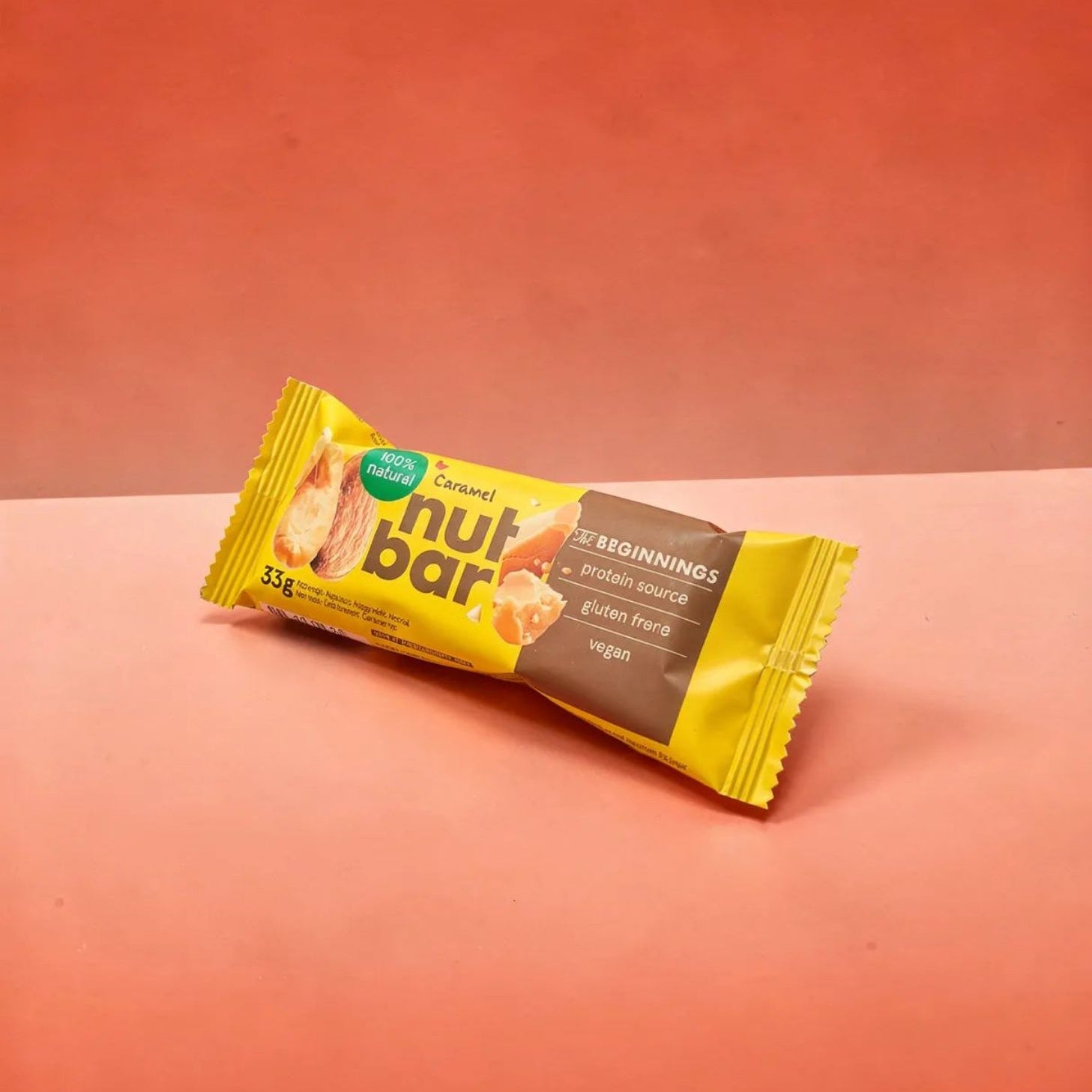 Nut bar packaging on a peach-colored background